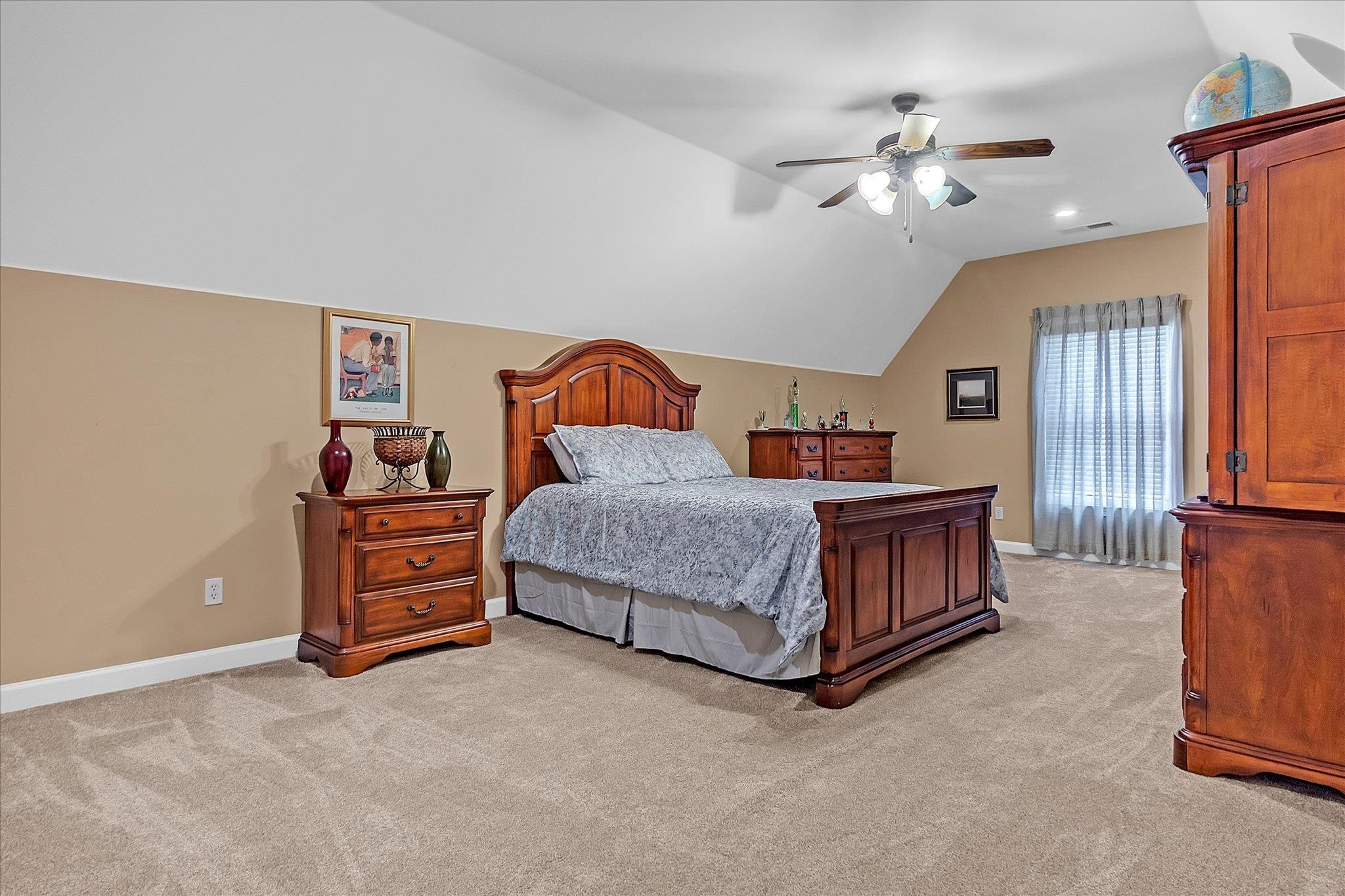 7284 Bucknell Road Millington, TN 38053 - Photo 31 of 35 Neutral-toned carpeting, two-tone wall paint, sloped ceiling, recessed lighting, and a ceiling fan with integrated lighting