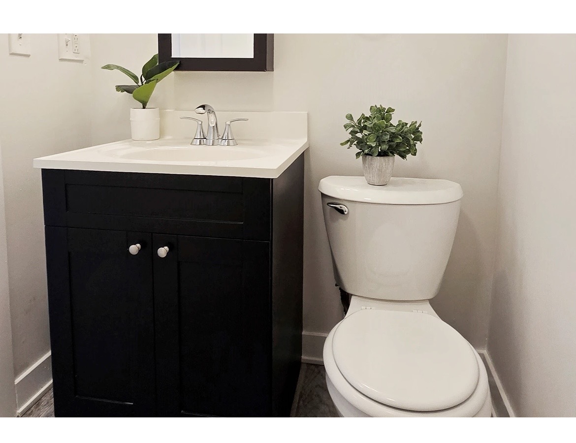 732 West Roscoe Street, Unit SGA Chicago, IL 60657 - Photo 12 of 13 a bathroom with a toilet sink and mirror