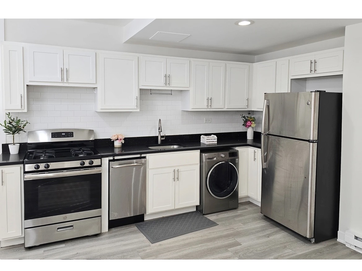732 West Roscoe Street, Unit SGA Chicago, IL 60657 - Photo 3 of 13 a kitchen with a stove top oven and refrigerator