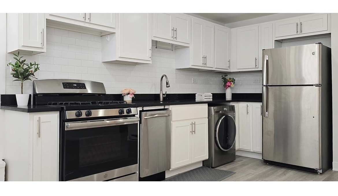732 West Roscoe Street, Unit SGA Chicago, IL 60657 - Photo 4 of 13 a kitchen with stainless steel appliances a refrigerator sink and cabinets