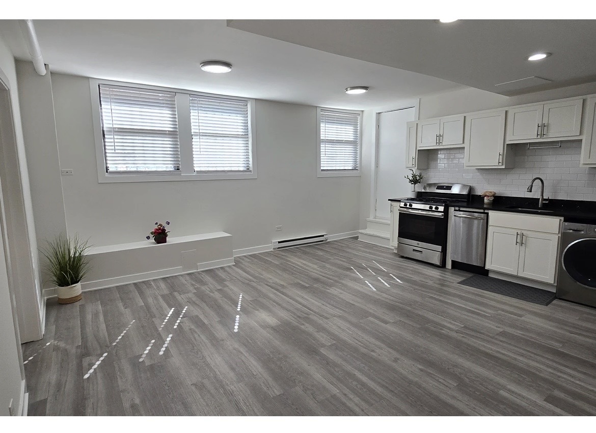 732 West Roscoe Street, Unit SGA Chicago, IL 60657 - Photo 6 of 13 a view of a kitchen with stainless steel appliances wooden floor and a window