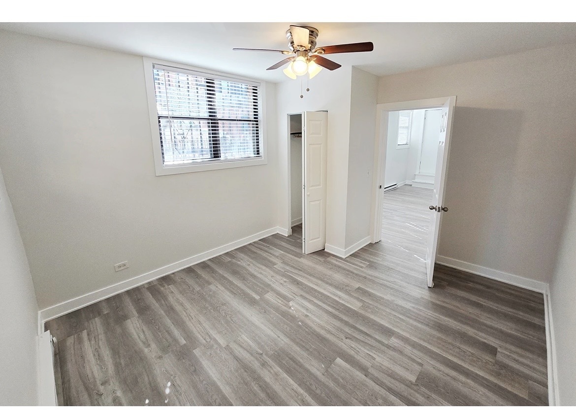 732 West Roscoe Street, Unit SGA Chicago, IL 60657 - Photo 9 of 13 a view of an empty room with wooden floor and a window
