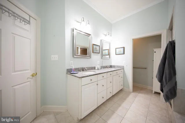 a kitchen with stainless steel appliances kitchen island granite countertop a refrigerator and a sink