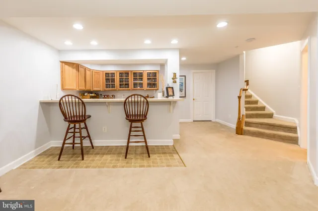 a view of a livingroom with a large window and chandelier