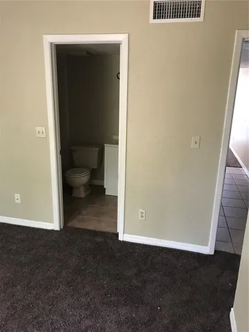 a view of a hallway with toilet