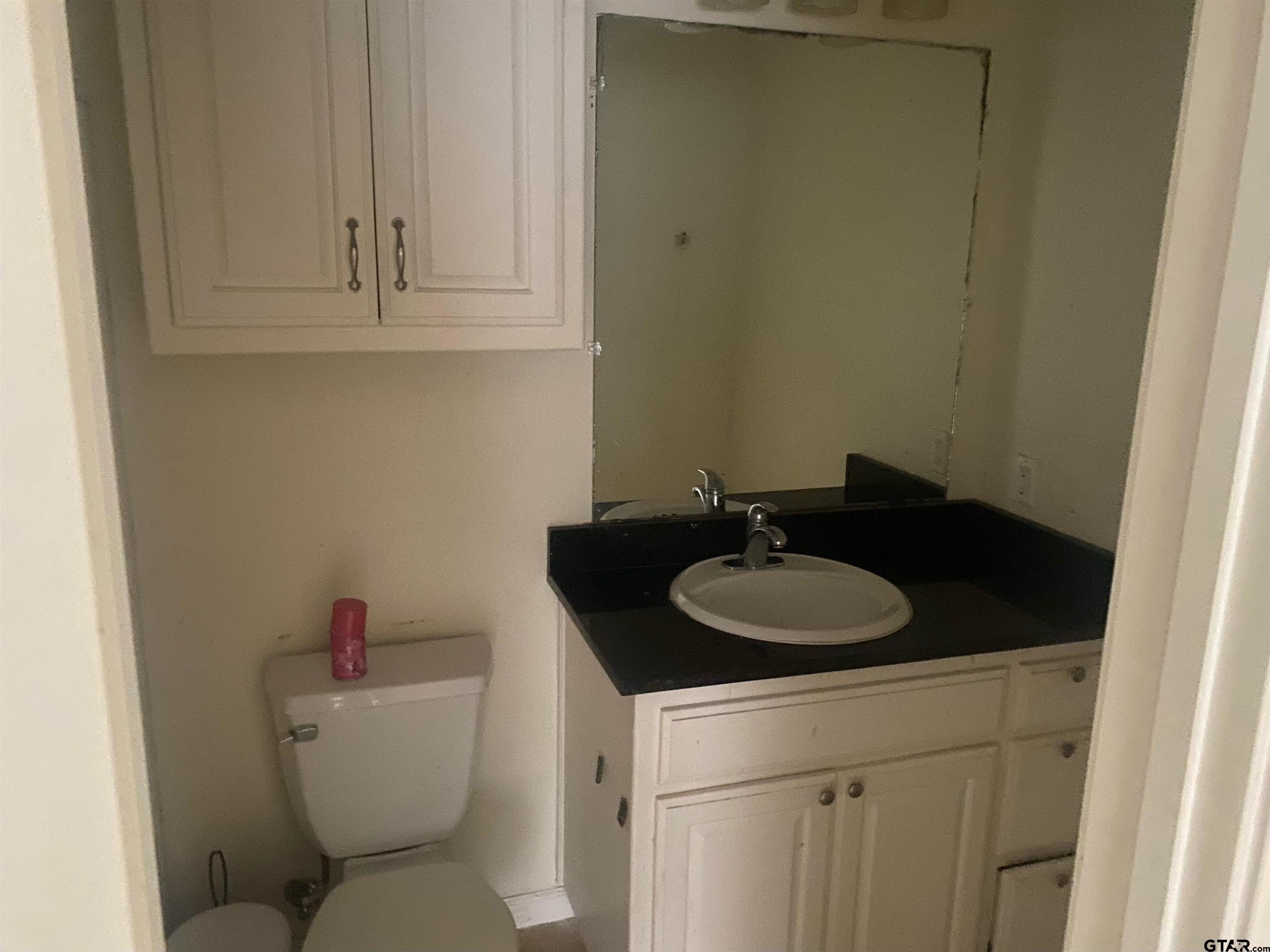 717 West Morris Street Tyler, TX 75702 - Photo 11 of 18 a bathroom with a sink and a toilet