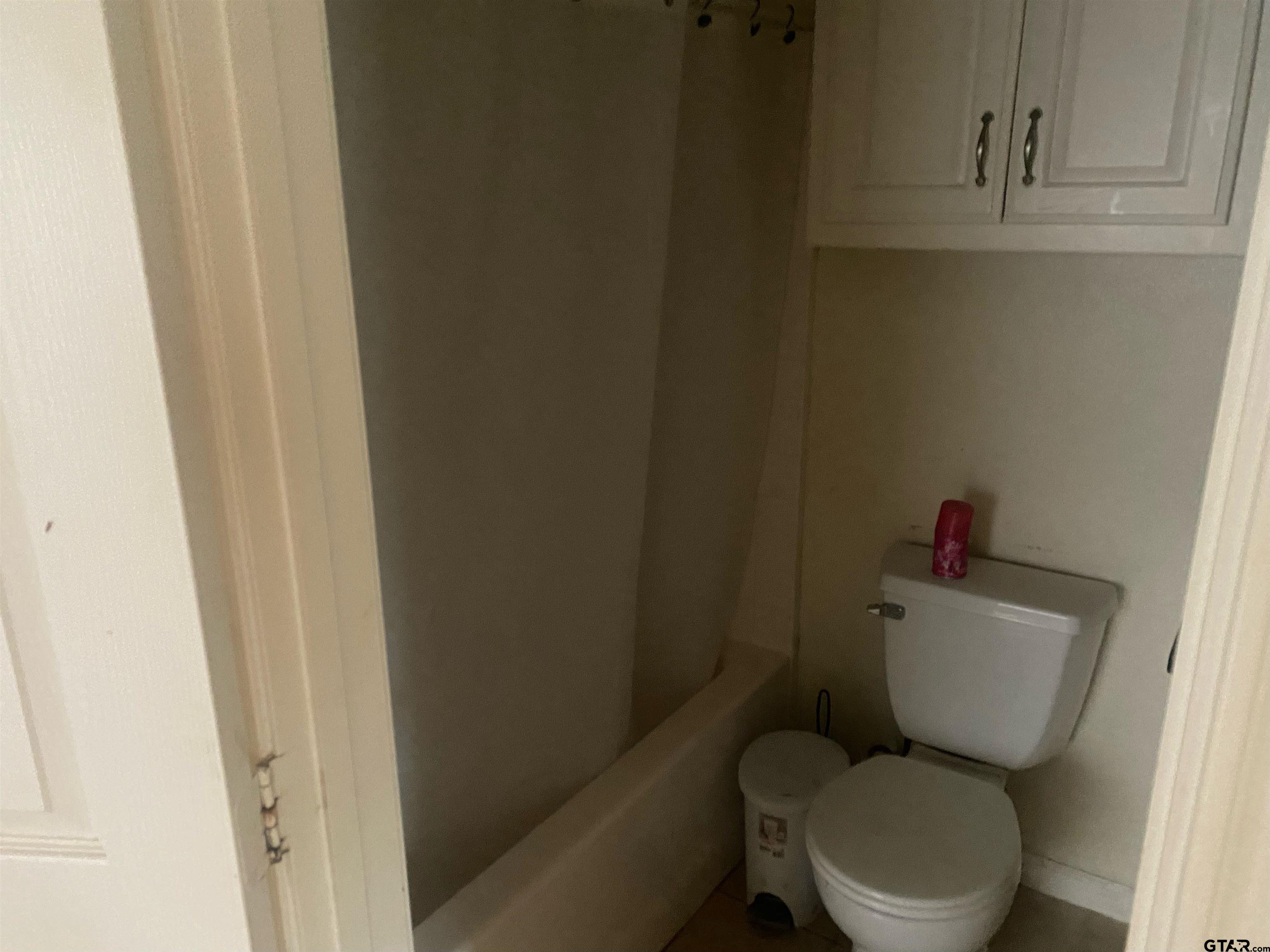 717 West Morris Street Tyler, TX 75702 - Photo 12 of 18 a white toilet sitting next to a bathroom sink