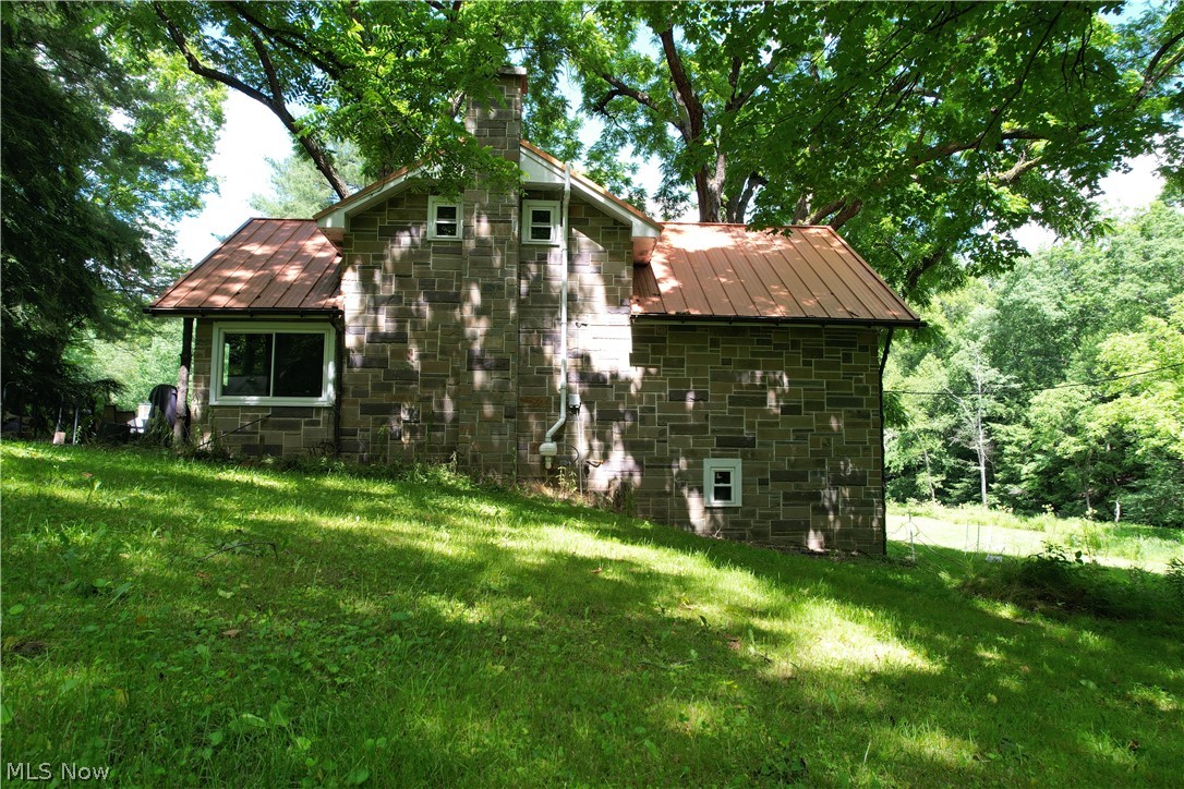 11811 Gaston Road Rogers, OH 44455 - Photo 7 of 38 The Cabin (stone-style facade) features 3 bedrooms, two bathrooms, a full-size basement, and is fully applianced with septic, well, and a geo-thermal furnace! Spend your evenings here while you build-out, or make the cabin your forever getaway and spend your days, hiking, hunting, or fishing!