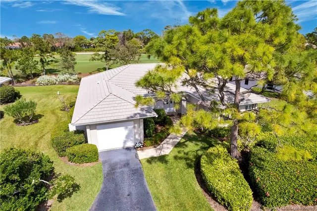 a view of a house with a yard and plants