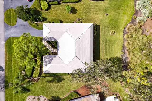 an aerial view of a house with a yard