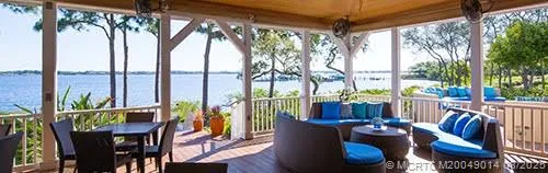a view of balcony with chairs and wooden fence