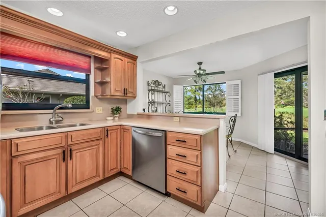 a kitchen with stainless steel appliances granite countertop a sink and a large window