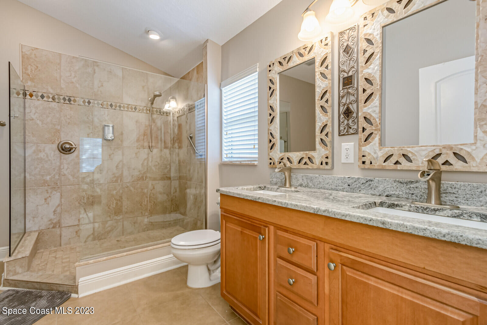 1569 Oconner Avenue Melbourne, FL 32940 - Photo 15 of 37 a bathroom with a granite countertop sink a toilet and shower