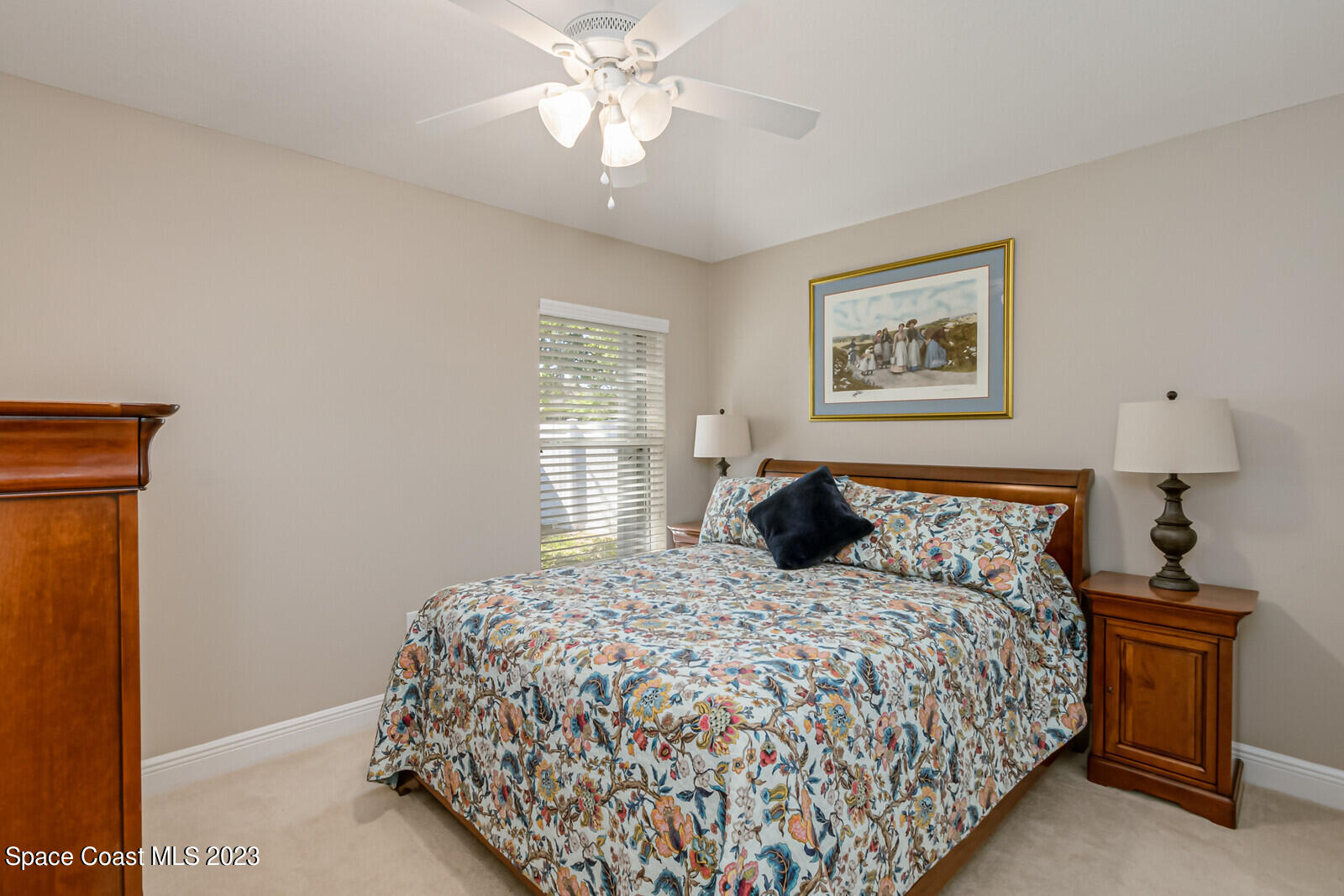 1569 Oconner Avenue Melbourne, FL 32940 - Photo 19 of 37 a bedroom with a bed and a chandelier