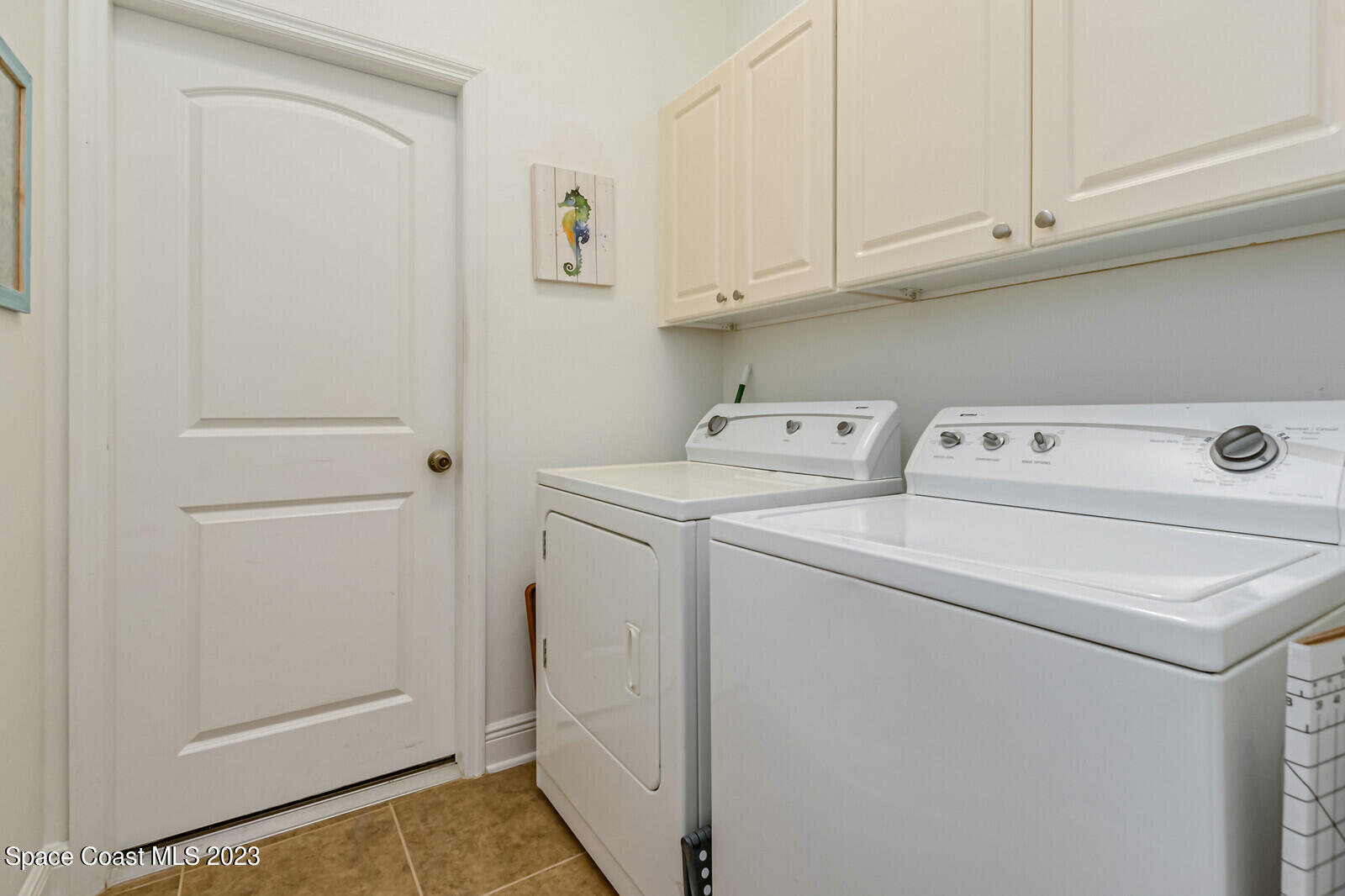 1569 Oconner Avenue Melbourne, FL 32940 - Photo 23 of 37 a utility room with dryer and washer