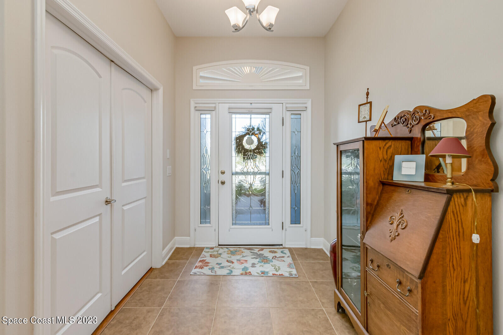 1569 Oconner Avenue Melbourne, FL 32940 - Photo 4 of 37 a bedroom with a bed and a chandelier