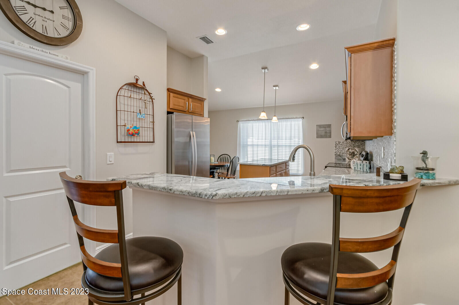 1569 Oconner Avenue Melbourne, FL 32940 - Photo 8 of 37 a kitchen with stainless steel appliances granite countertop a table and chairs