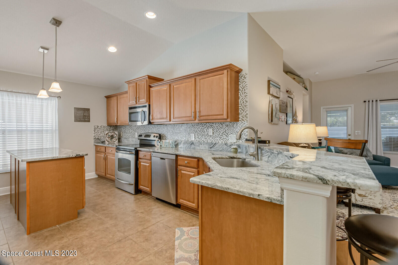 1569 Oconner Avenue Melbourne, FL 32940 - Photo 9 of 37 a kitchen with stainless steel appliances granite countertop a sink stove and refrigerator