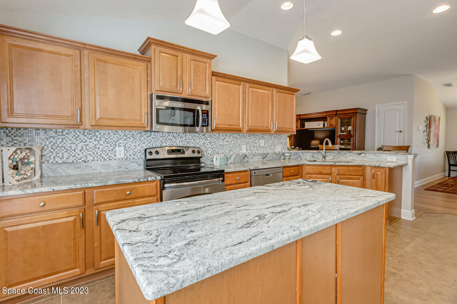 1569 Oconner Avenue Melbourne, FL 32940 - Photo 10 of 37 a kitchen with stainless steel appliances granite countertop a sink stove and microwave