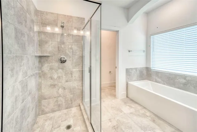 a bathroom with a bathtub and a shower