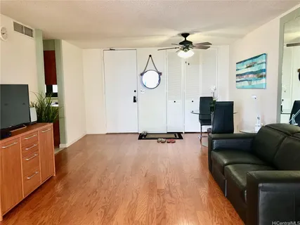 a living room with furniture a large window and a flat screen tv