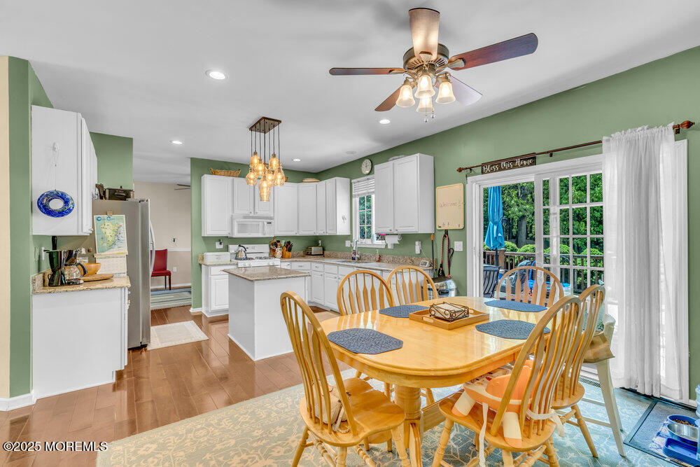 41 Hampshire Boulevard Jackson, NJ 08527 - Photo 12 of 55 a dining room with furniture a kitchen view and a chandelier