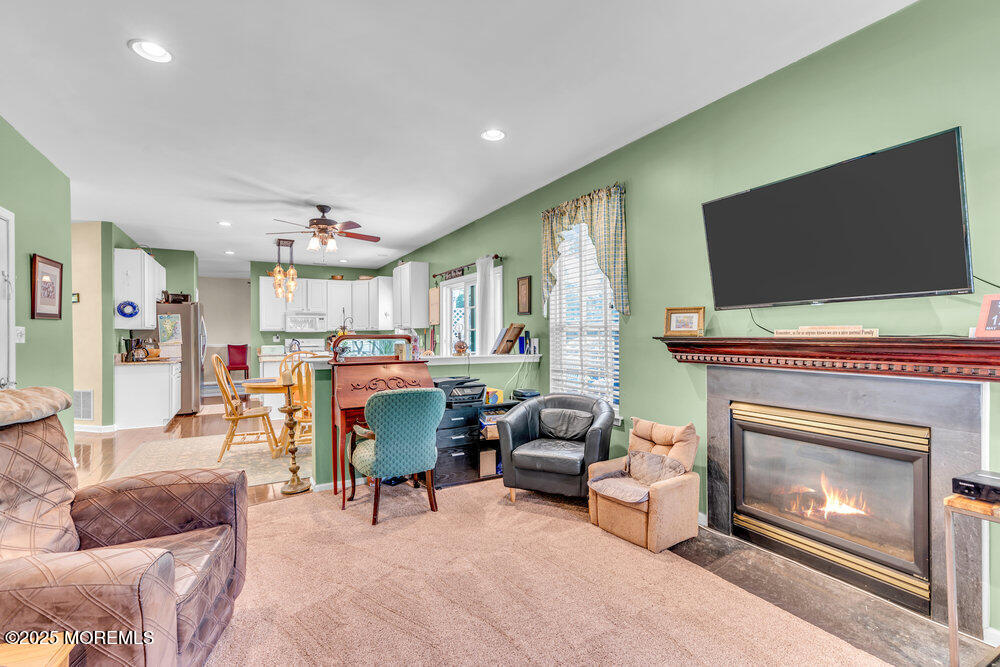 41 Hampshire Boulevard Jackson, NJ 08527 - Photo 15 of 55 a living room with furniture a flat screen tv and a fireplace