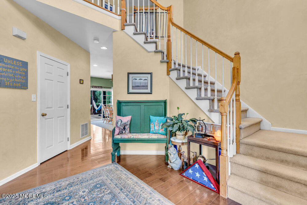 41 Hampshire Boulevard Jackson, NJ 08527 - Photo 9 of 55 a living room with stairs and a rug