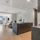 a large kitchen with lots of counter top space and a wooden floor