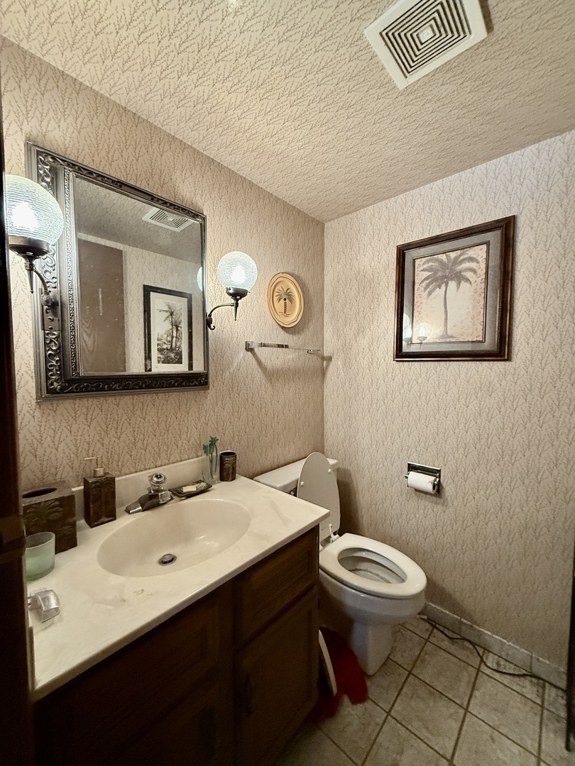 1545 Winnetka Road, Unit 1545 Glenview, IL 60025 - Photo 3 of 14 a bathroom with a toilet a sink and mirror