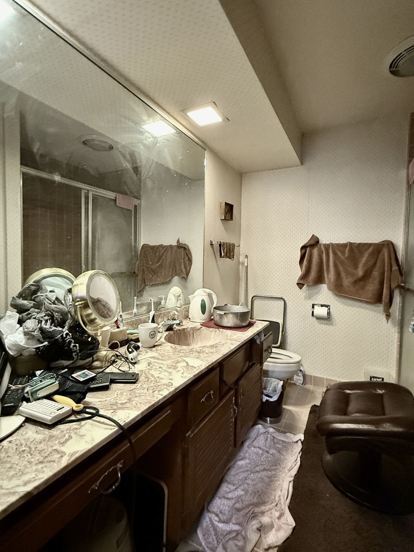 1545 Winnetka Road, Unit 1545 Glenview, IL 60025 - Photo 7 of 14 a bathroom with a granite countertop sink and a mirror