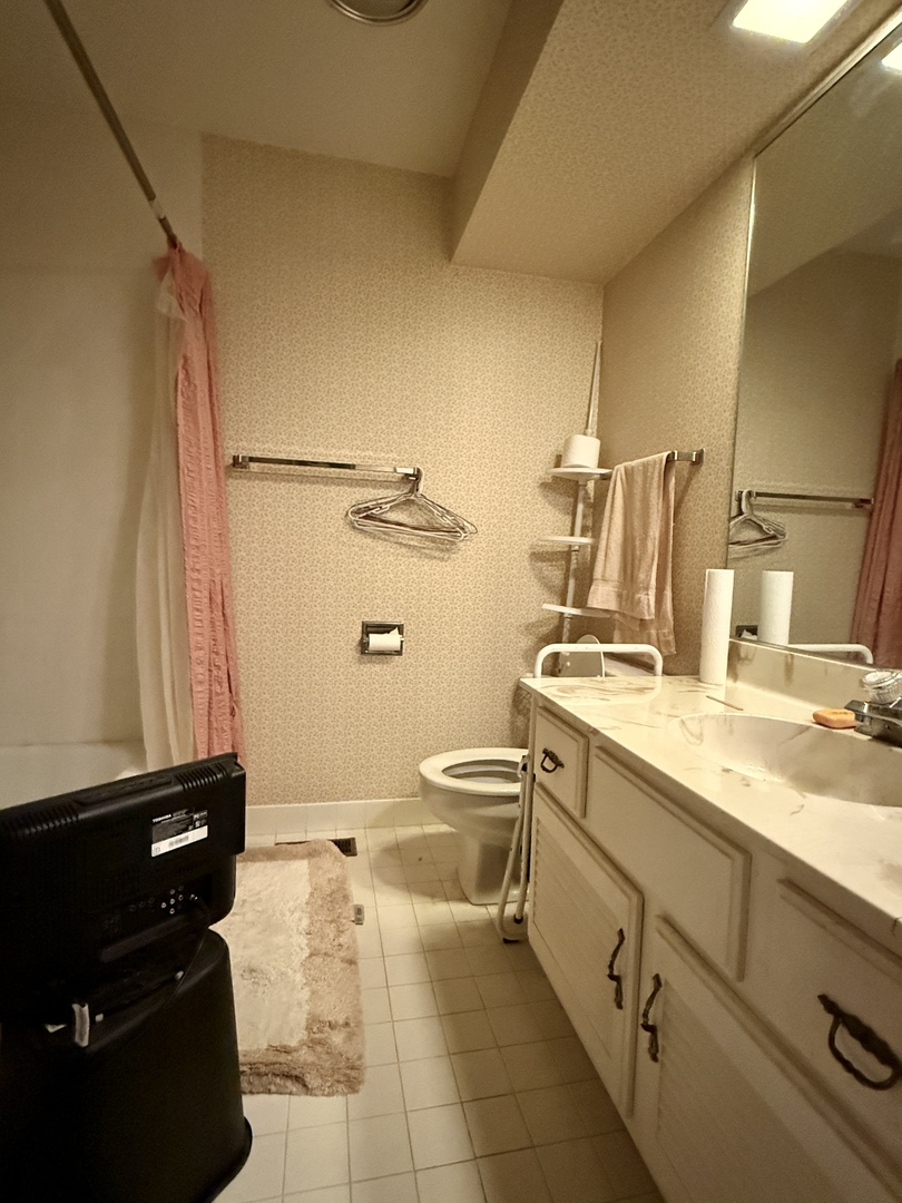 1545 Winnetka Road, Unit 1545 Glenview, IL 60025 - Photo 9 of 14 a bathroom with a granite countertop sink toilet and a mirror