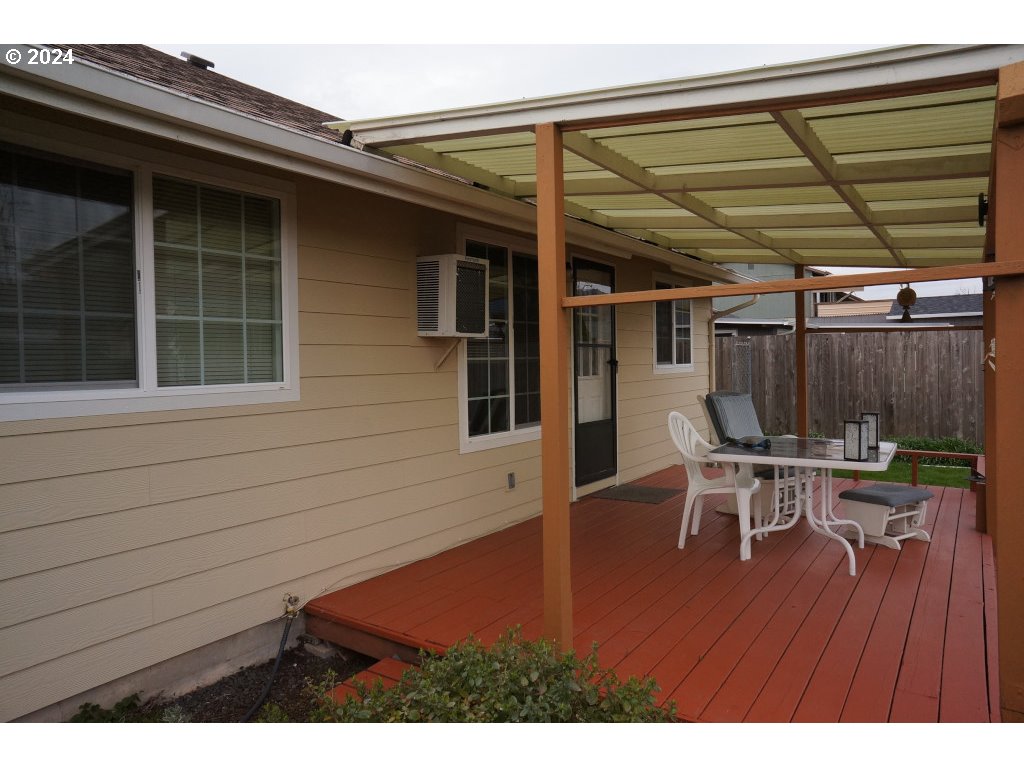 5637 E Street Springfield, OR 97478 - Photo 19 of 27 a view of a patio with table and chairs with wooden floor and fence