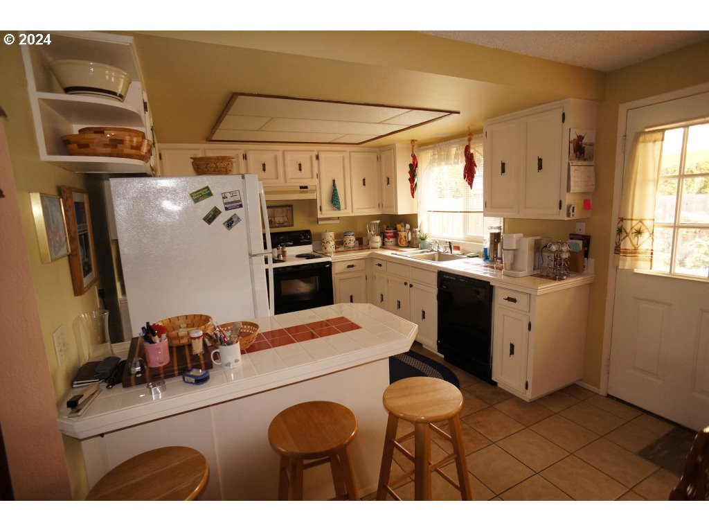 5637 E Street Springfield, OR 97478 - Photo 8 of 27 a kitchen with a sink stove and refrigerator