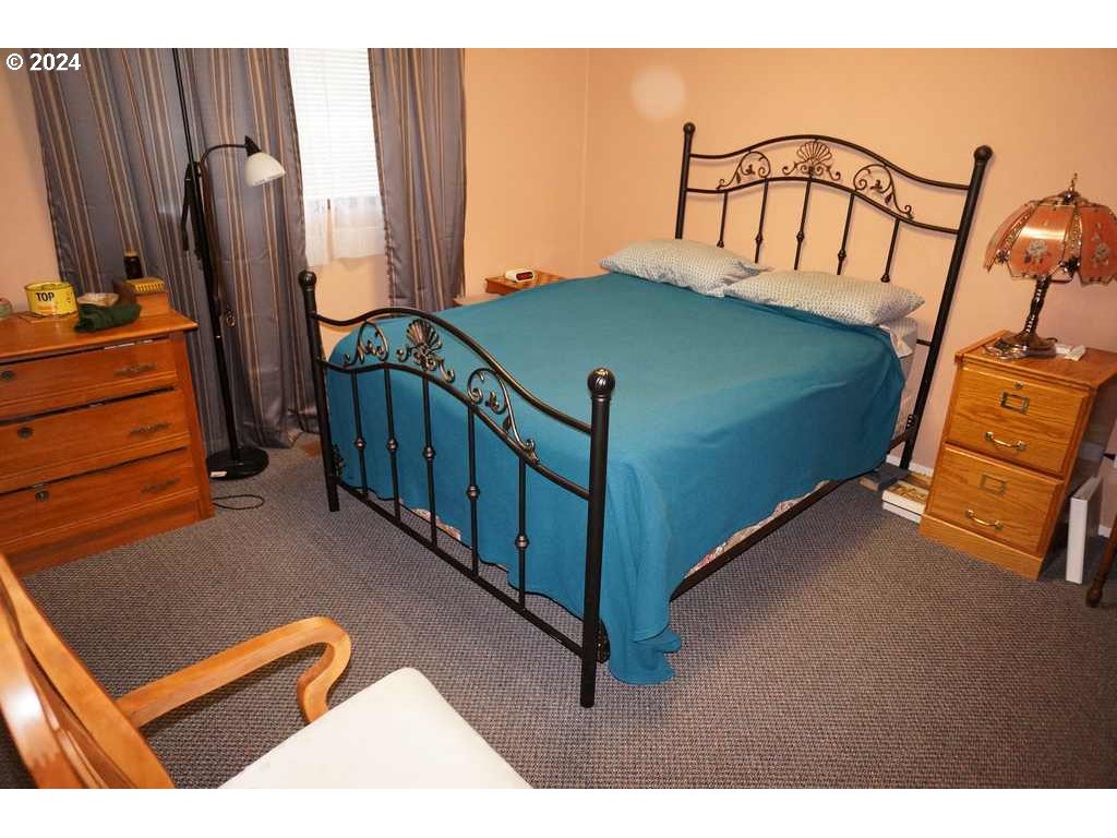 5637 E Street Springfield, OR 97478 - Photo 10 of 27 a bedroom with furniture and a window