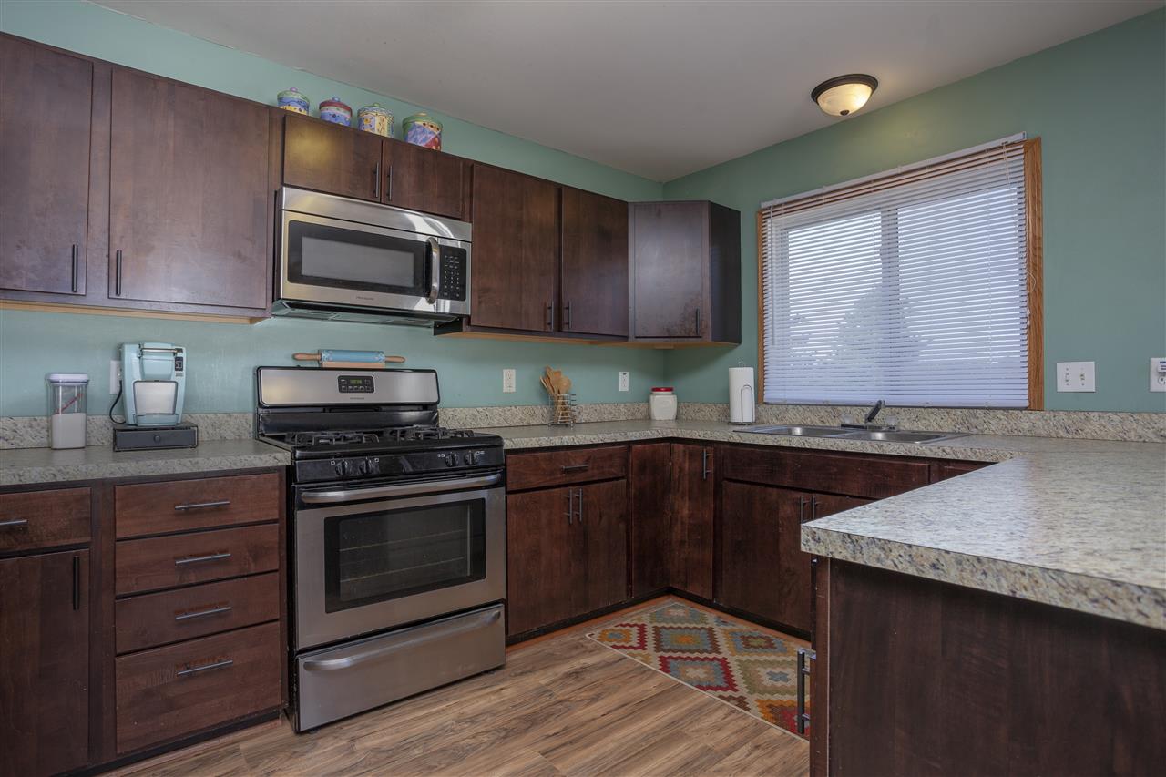 519 Pembroke Road Southwest Poplar Grove, IL 61065 - Photo 8 of 25 a kitchen with stainless steel appliances granite countertop a stove a sink dishwasher and a microwave oven with wooden cabinets