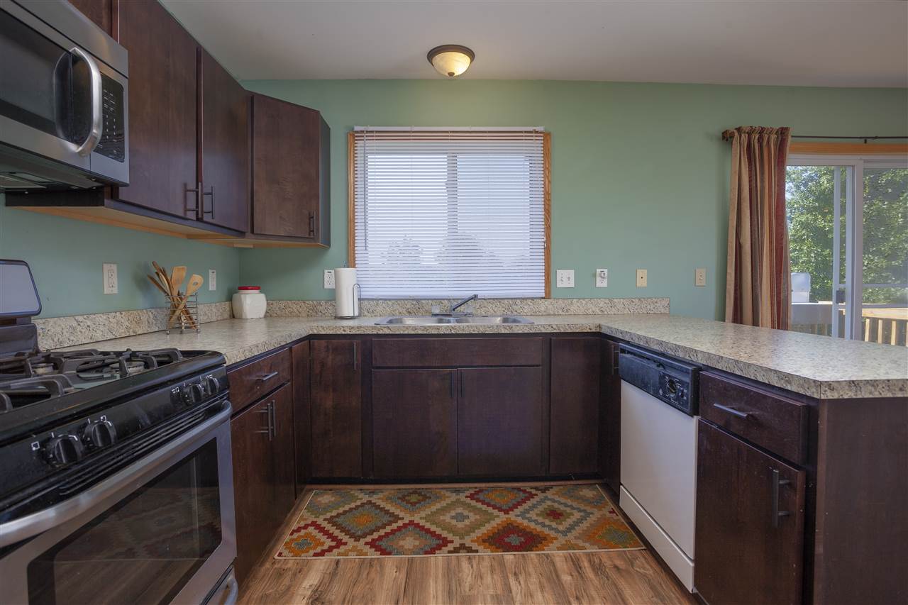 519 Pembroke Road Southwest Poplar Grove, IL 61065 - Photo 9 of 25 a kitchen with granite countertop a stove and a sink
