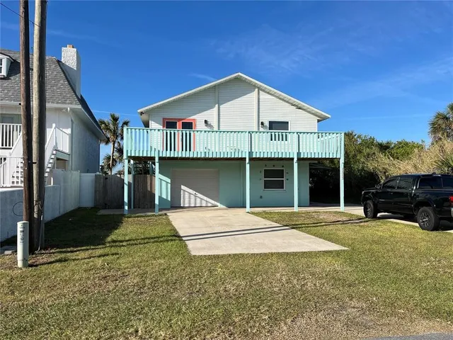 a view of a house with a balcony and door