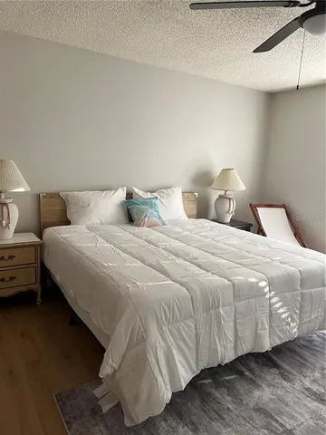 a bedroom with a bed and a night stand