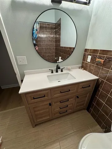a bathroom with a sink mirror and vanity
