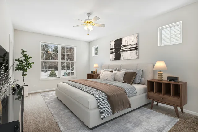 a bedroom with a large bed and a potted plant