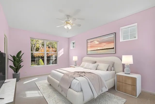 a bedroom with a large bed and a chandelier