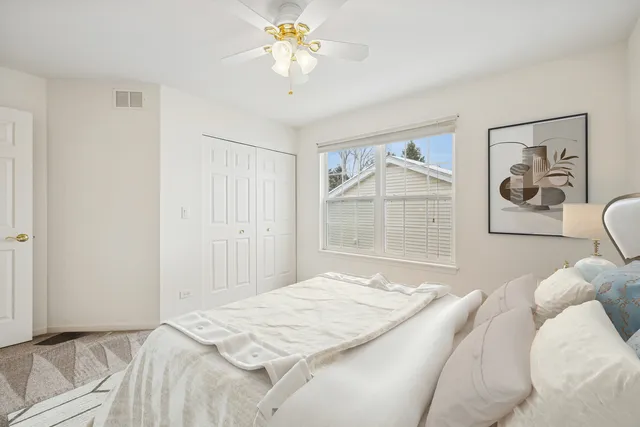 a bedroom with a bed and a painting on the wall