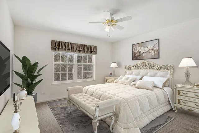 a bedroom with a large bed and a window