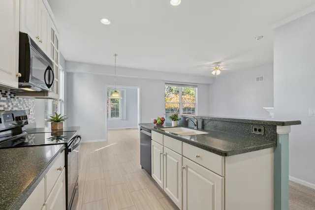 a kitchen that has a sink a stove and window