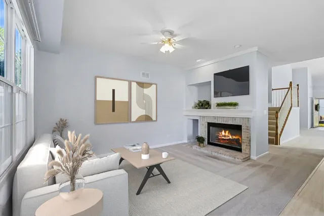 a living room with furniture a flat screen tv and a fireplace