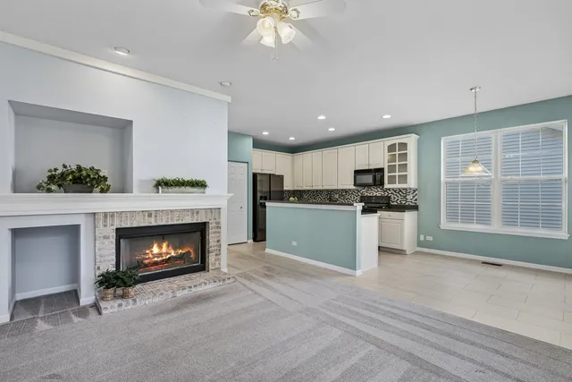 a kitchen with a fireplace and a refrigerator