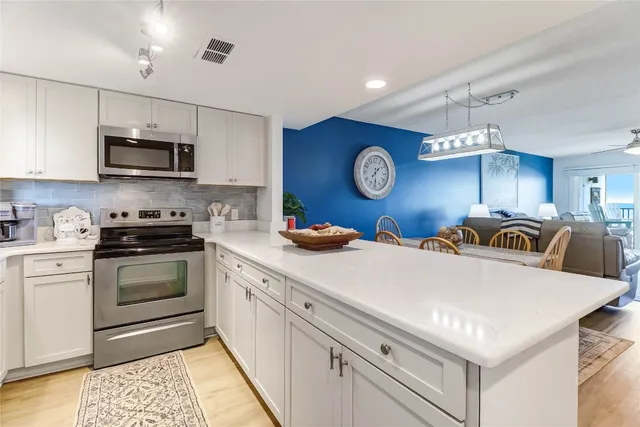 a view of a dining room with furniture and a chandelier