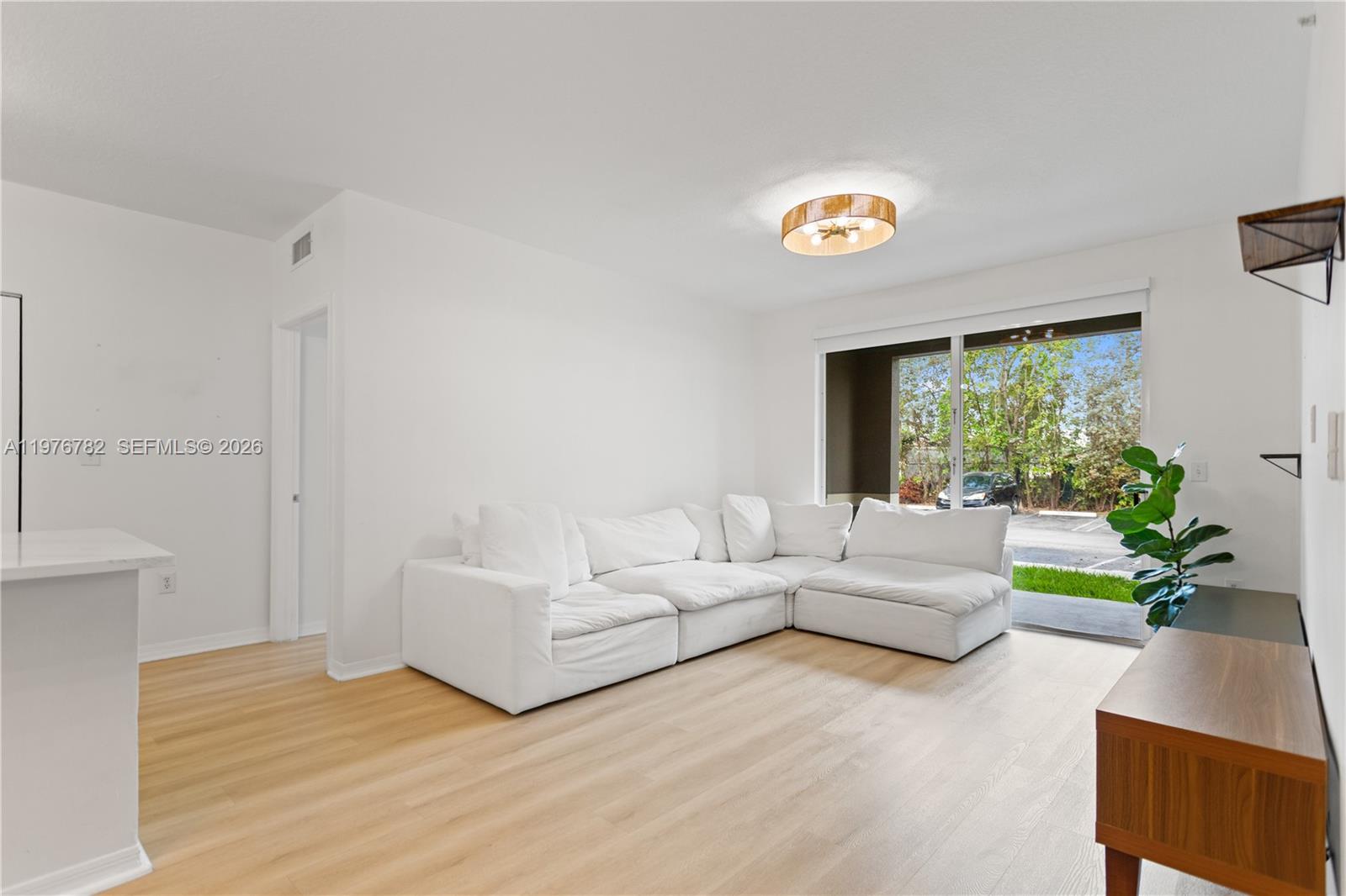 6851 Southwest 44th Street, Unit 107 Miami, FL 33155 - Photo 11 of 41 a living room with furniture and a window