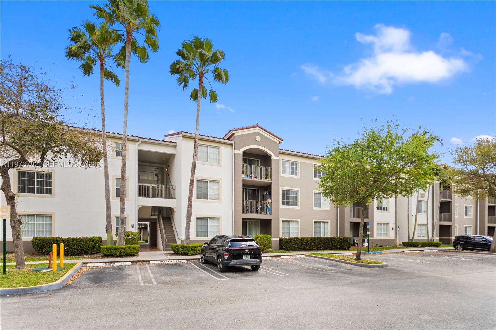6851 Southwest 44th Street, Unit 107 Miami, FL 33155 - Photo 17 of 41 a car parked in front of a building